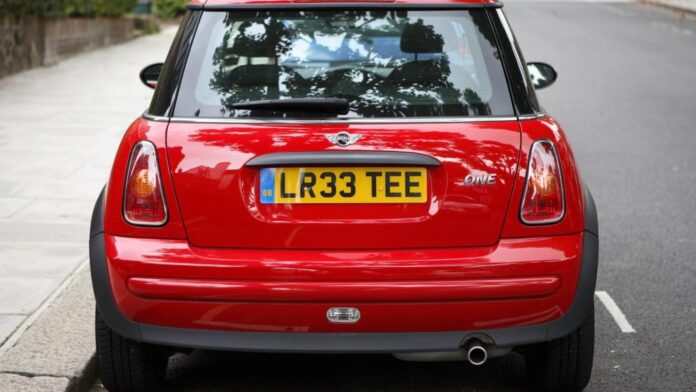 A red car with UK license plates