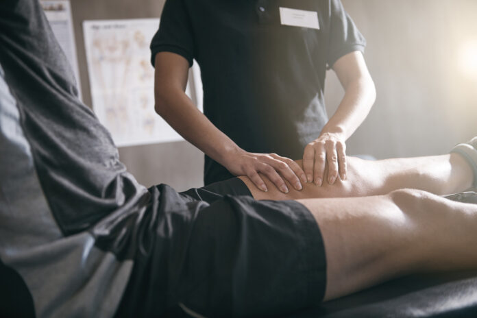 Doctor giving sports massage